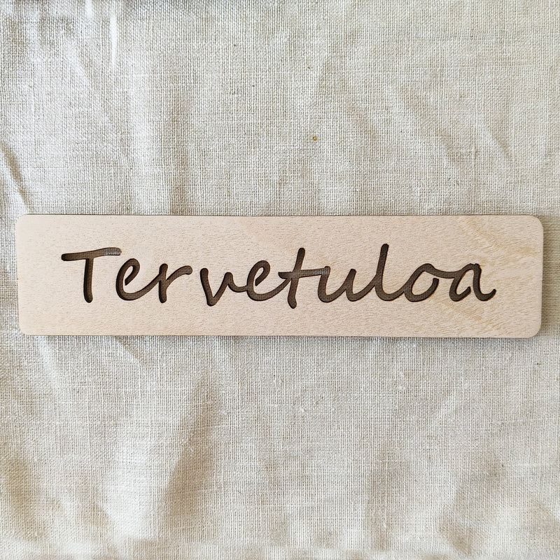 Puinen tervetuloa- kyltti